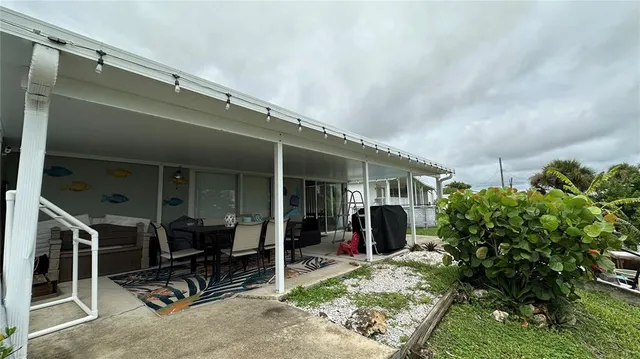 a view of backyard with swimming pool and outdoor seating
