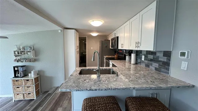 a kitchen with kitchen island granite countertop a sink and counter space
