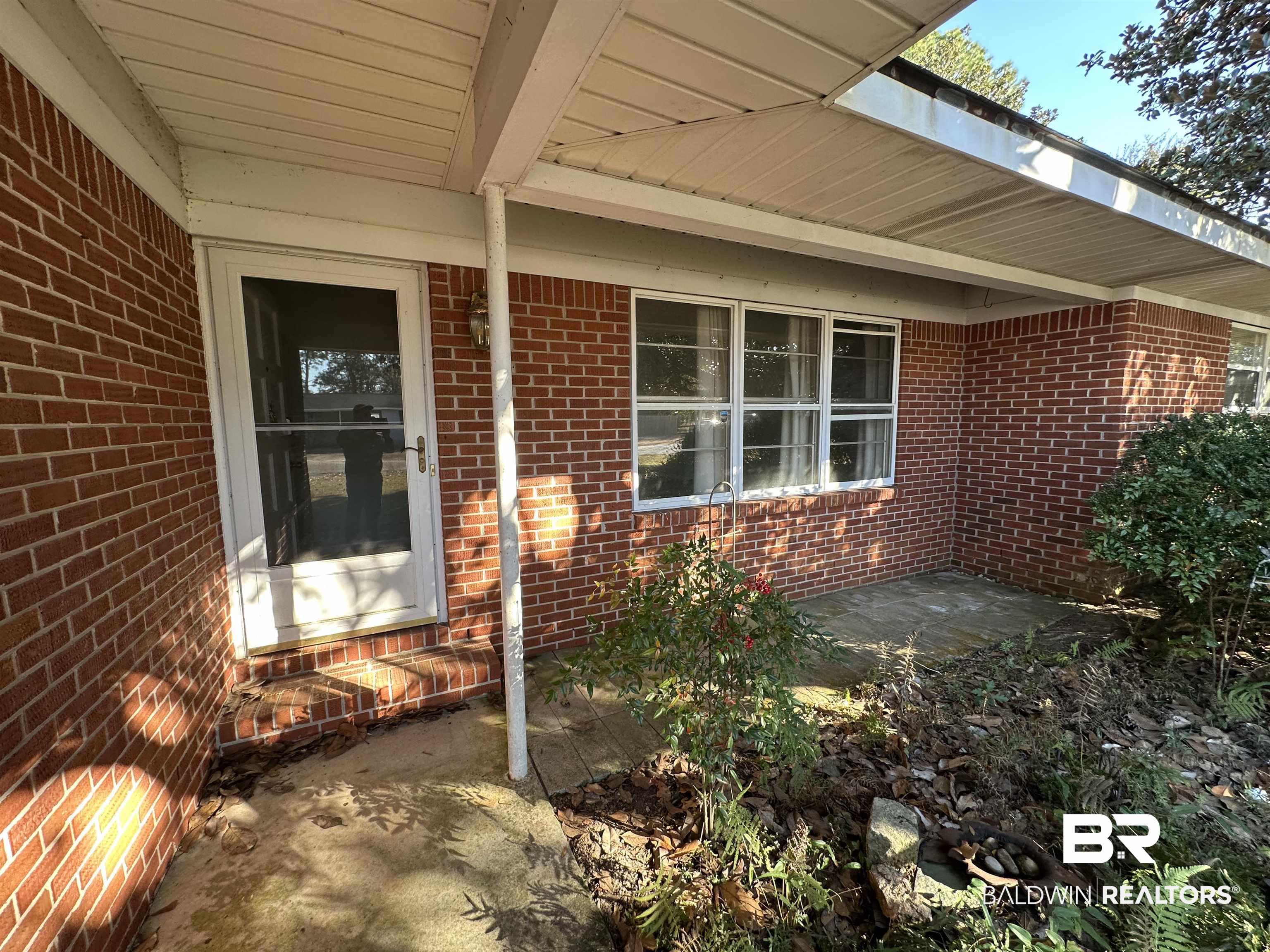 1 Yupon Circle Foley, AL 36535 - Photo 8 of 30 Doorway to property featuring brick siding and a patio area