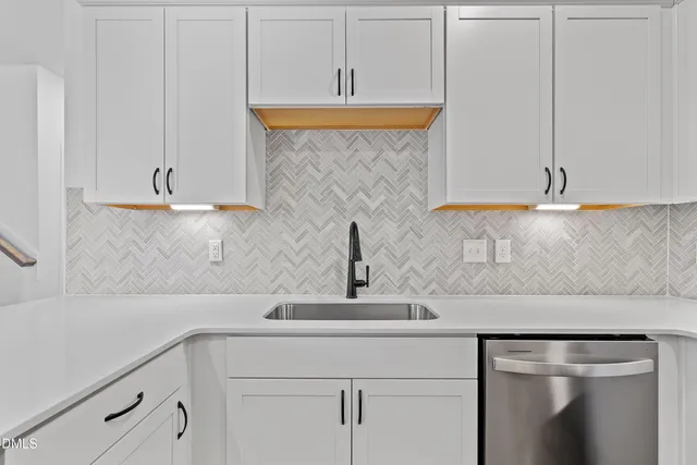 a kitchen with a sink and cabinets