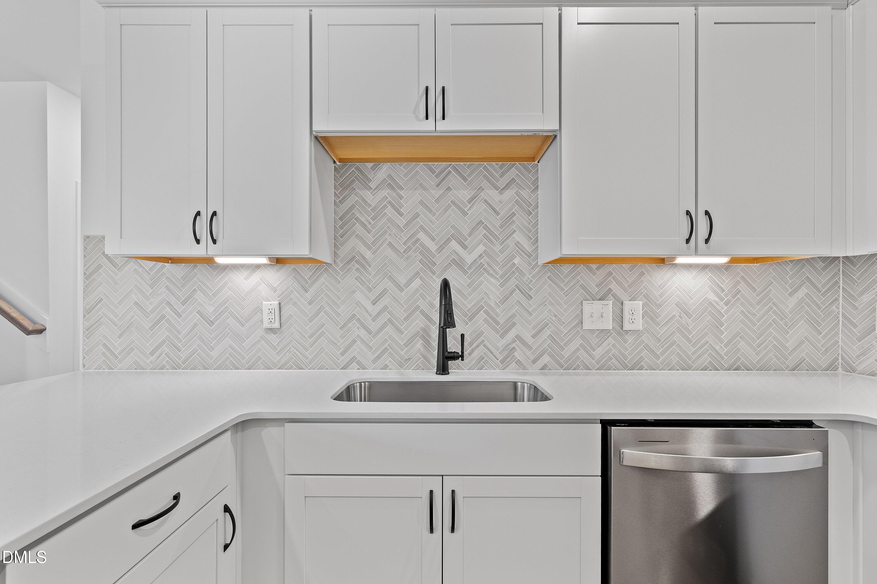 115 Swain Street Clayton, NC 27527 - Photo 14 of 46 a kitchen with a sink and cabinets