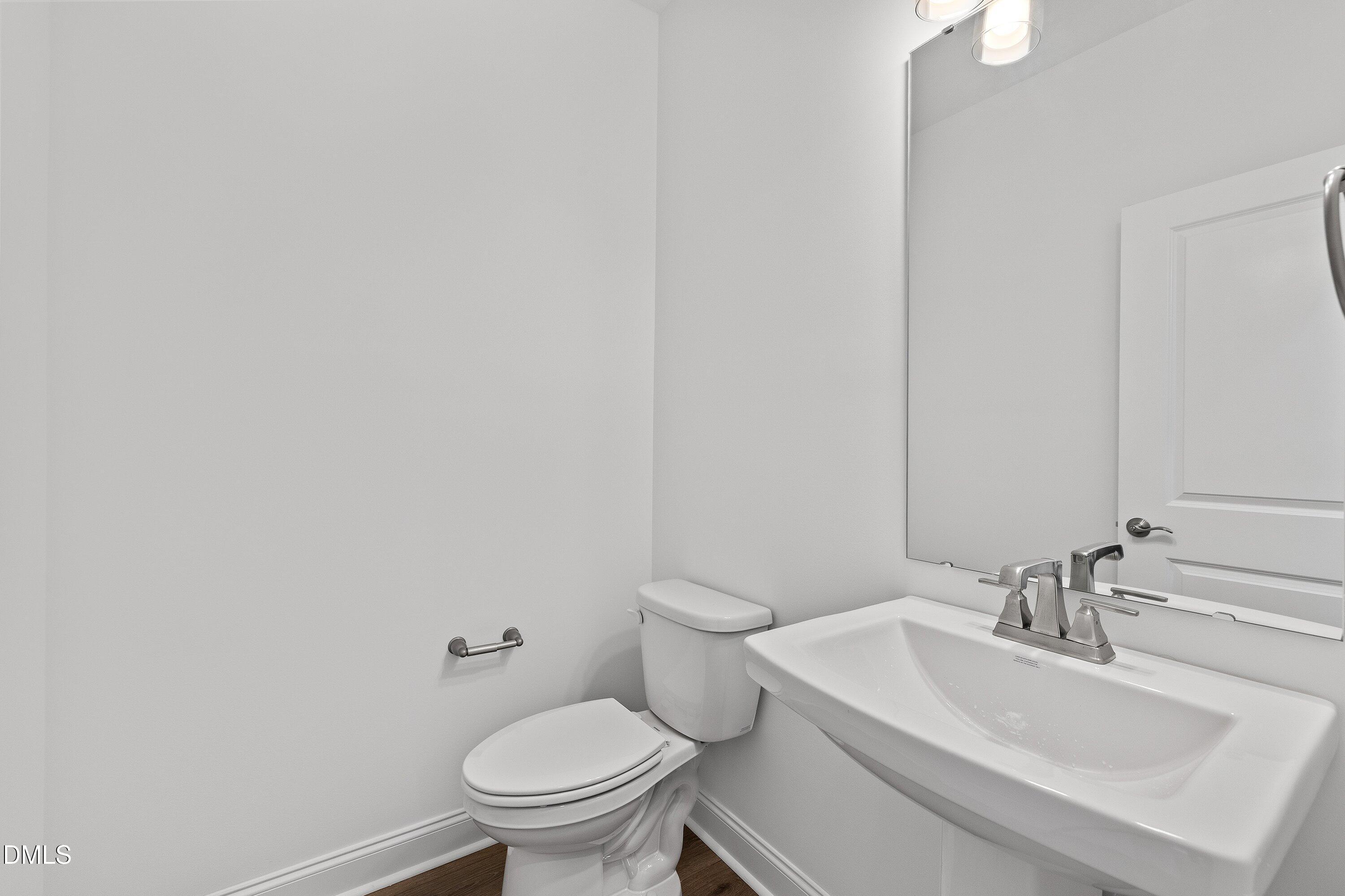 115 Swain Street Clayton, NC 27527 - Photo 19 of 46 a bathroom with a sink a toilet and a mirror
