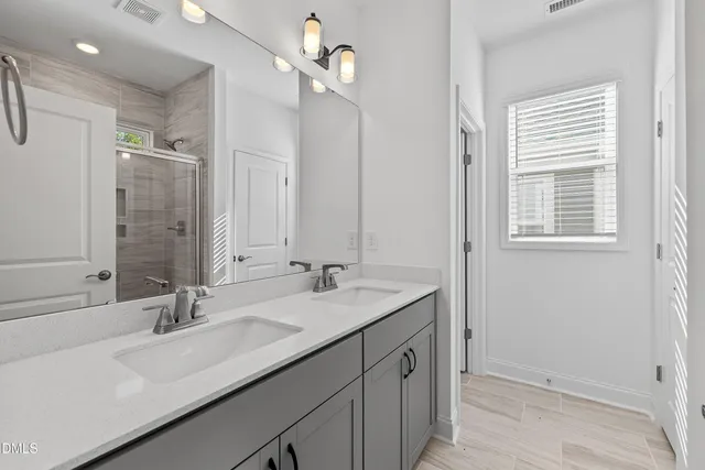 a bathroom with a sink double vanity and a mirror