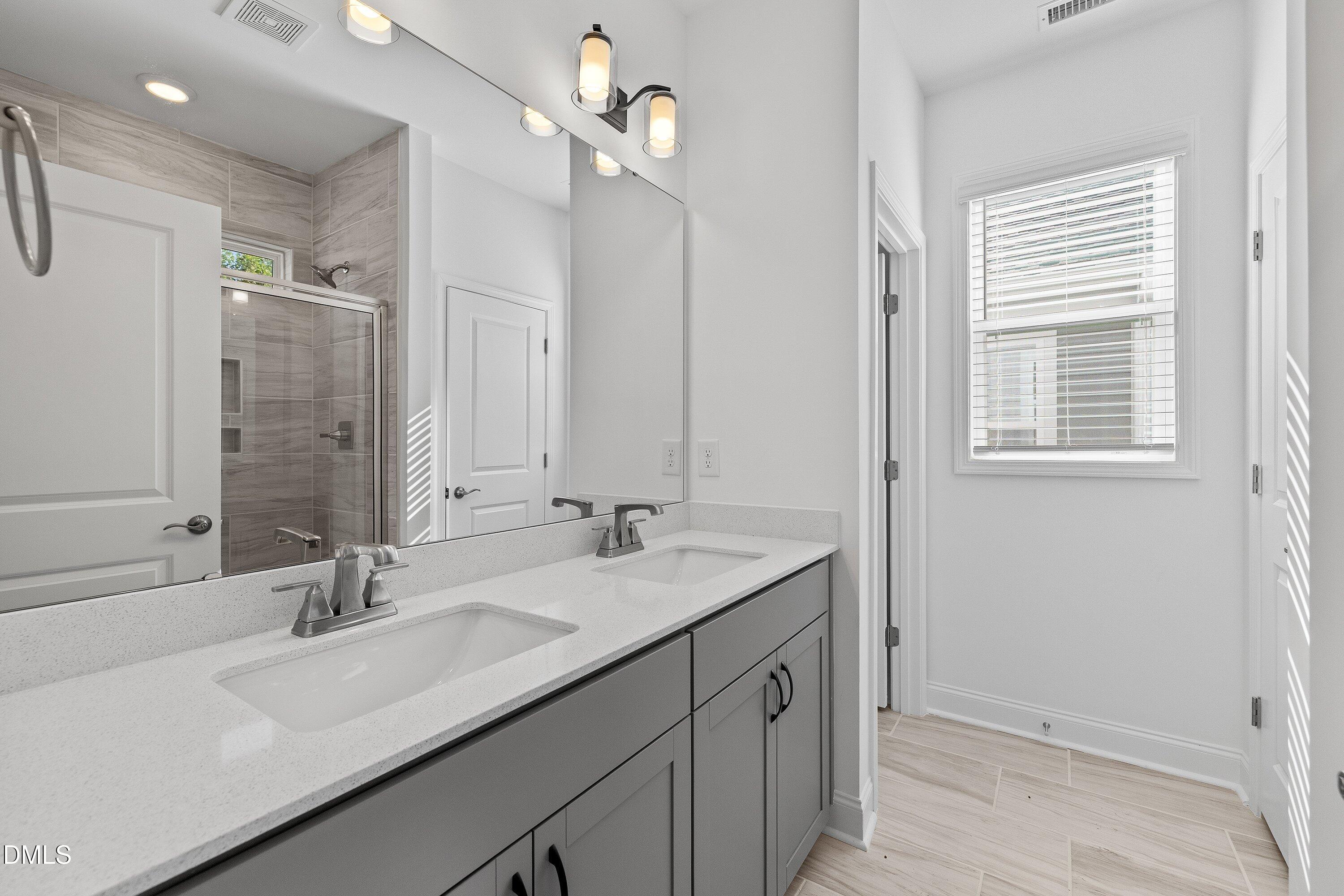 115 Swain Street Clayton, NC 27527 - Photo 24 of 46 a bathroom with a sink double vanity and a mirror