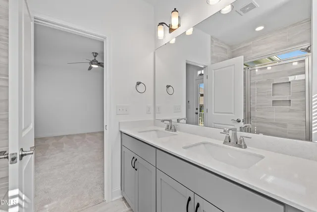 a bathroom with a sink double vanity and shower