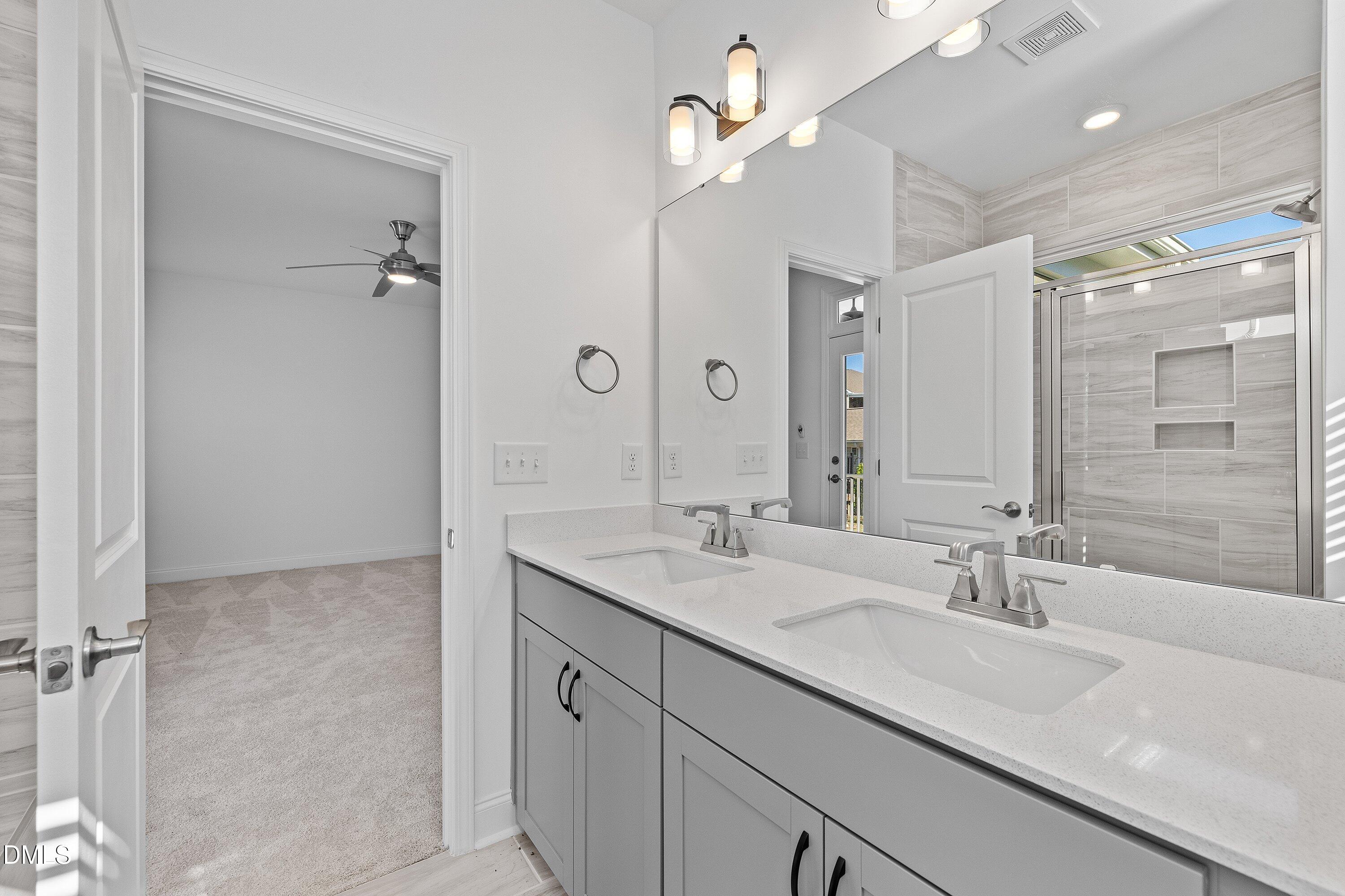 115 Swain Street Clayton, NC 27527 - Photo 25 of 46 a bathroom with a sink double vanity and shower