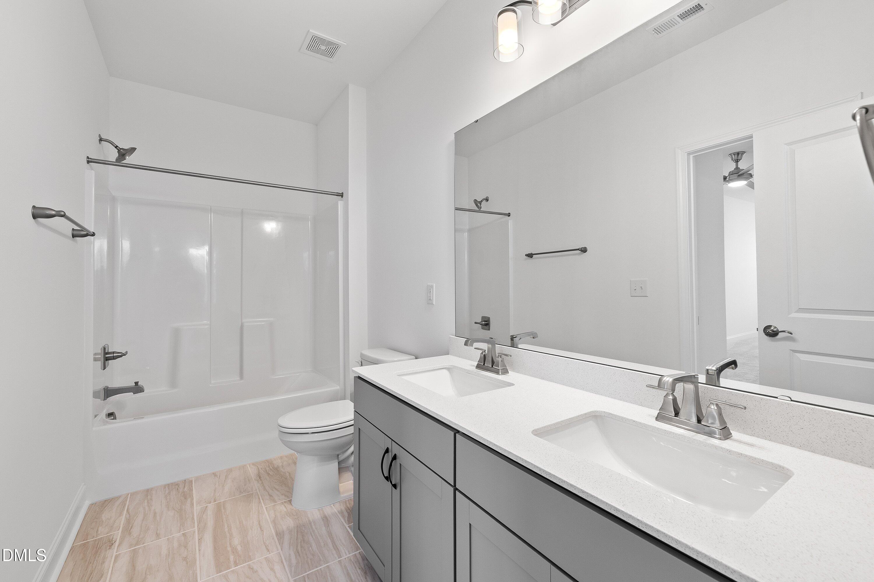 115 Swain Street Clayton, NC 27527 - Photo 30 of 46 a bathroom with a sink double vanity granite toilet and shower