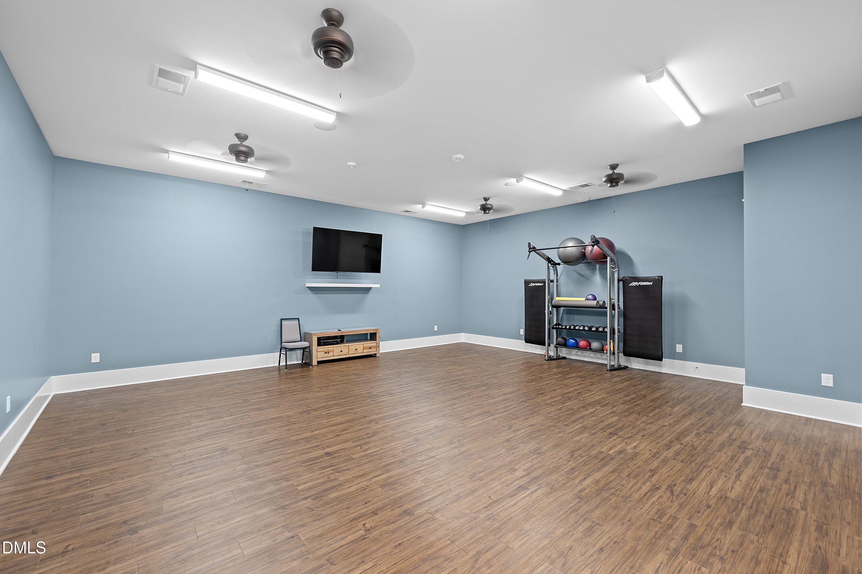 115 Swain Street Clayton, NC 27527 - Photo 39 of 46 an empty room with wooden floor and furniture