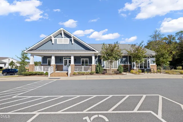 a patio with a table and chairs and a barbeque