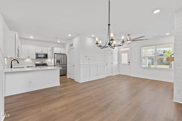 a view of a kitchen with marble kitchen and stainless steel appliances