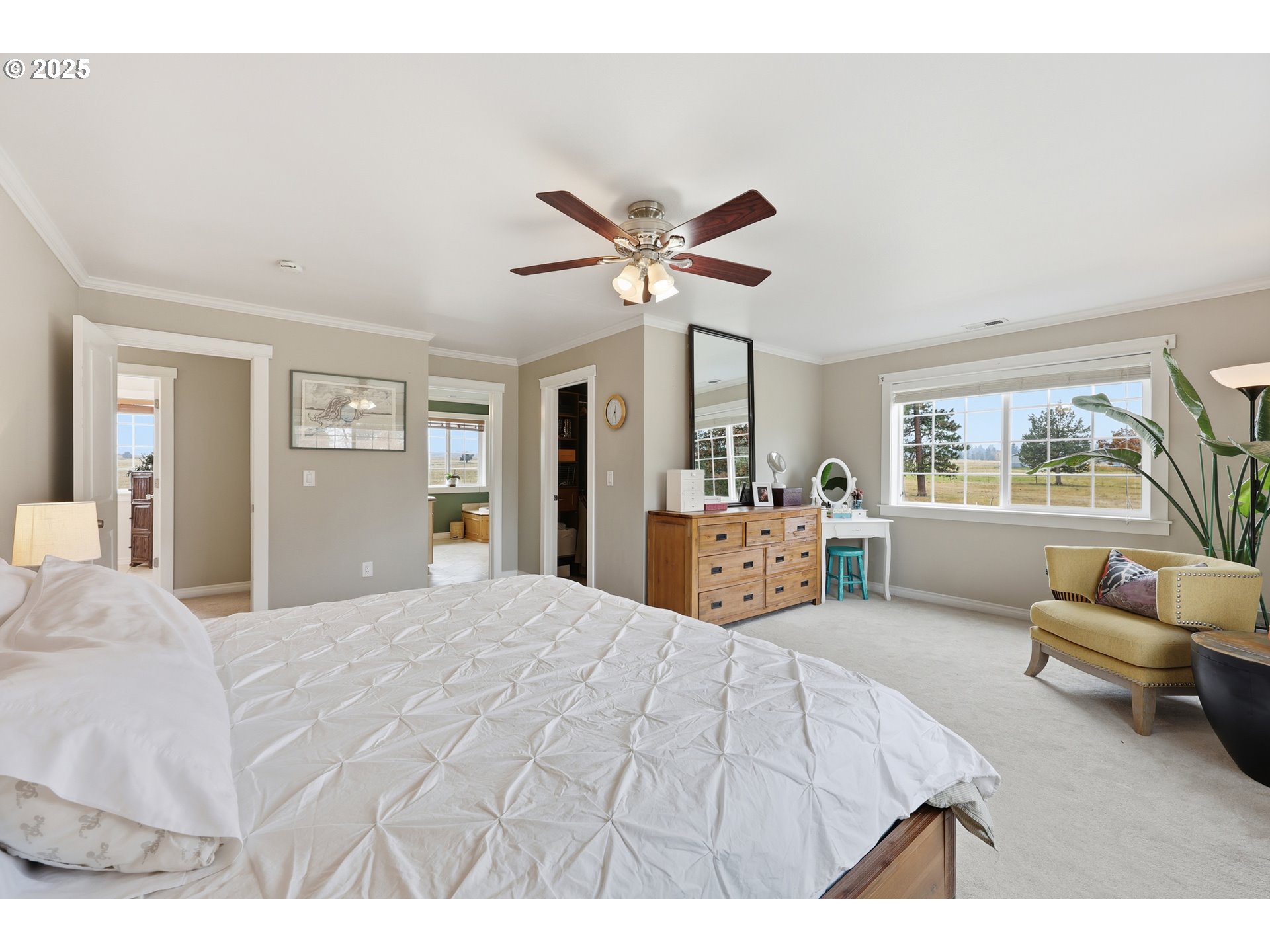 54472 Smock Road Tygh Valley, OR 97063 - Photo 24 of 48 a spacious bedroom with a bed a couch and a large window