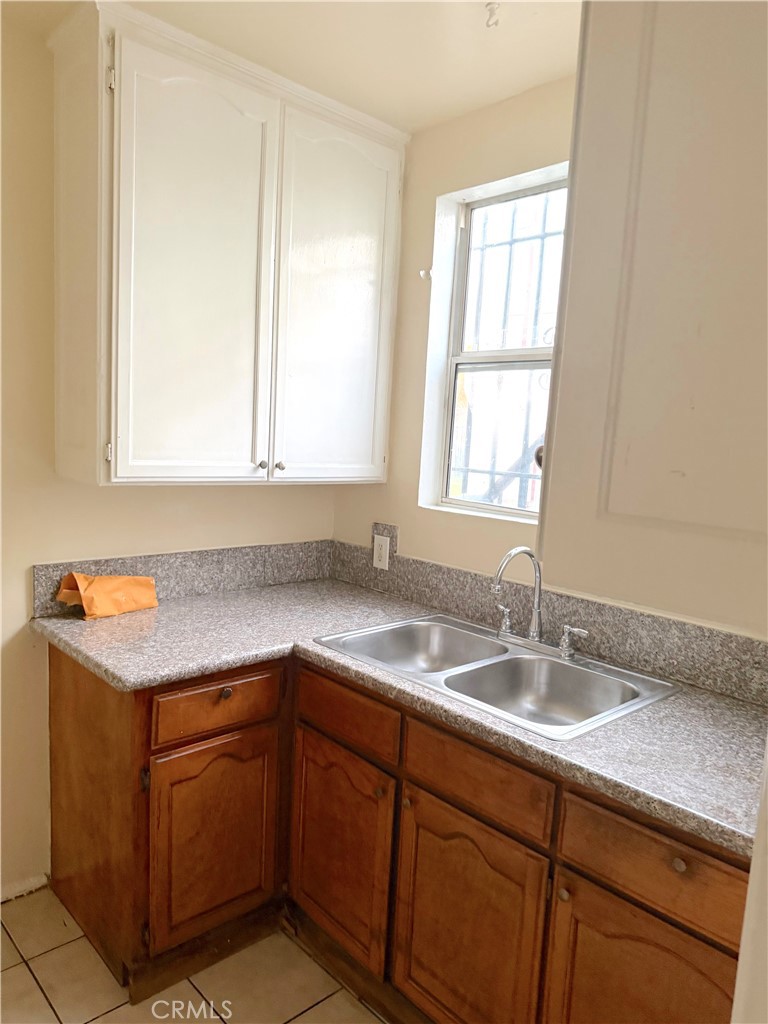 1925 West 35th Street Los Angeles, CA 90018 - Photo 8 of 11 a kitchen with a sink cabinets and window