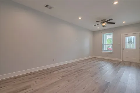 wooden floor in an empty room with a window
