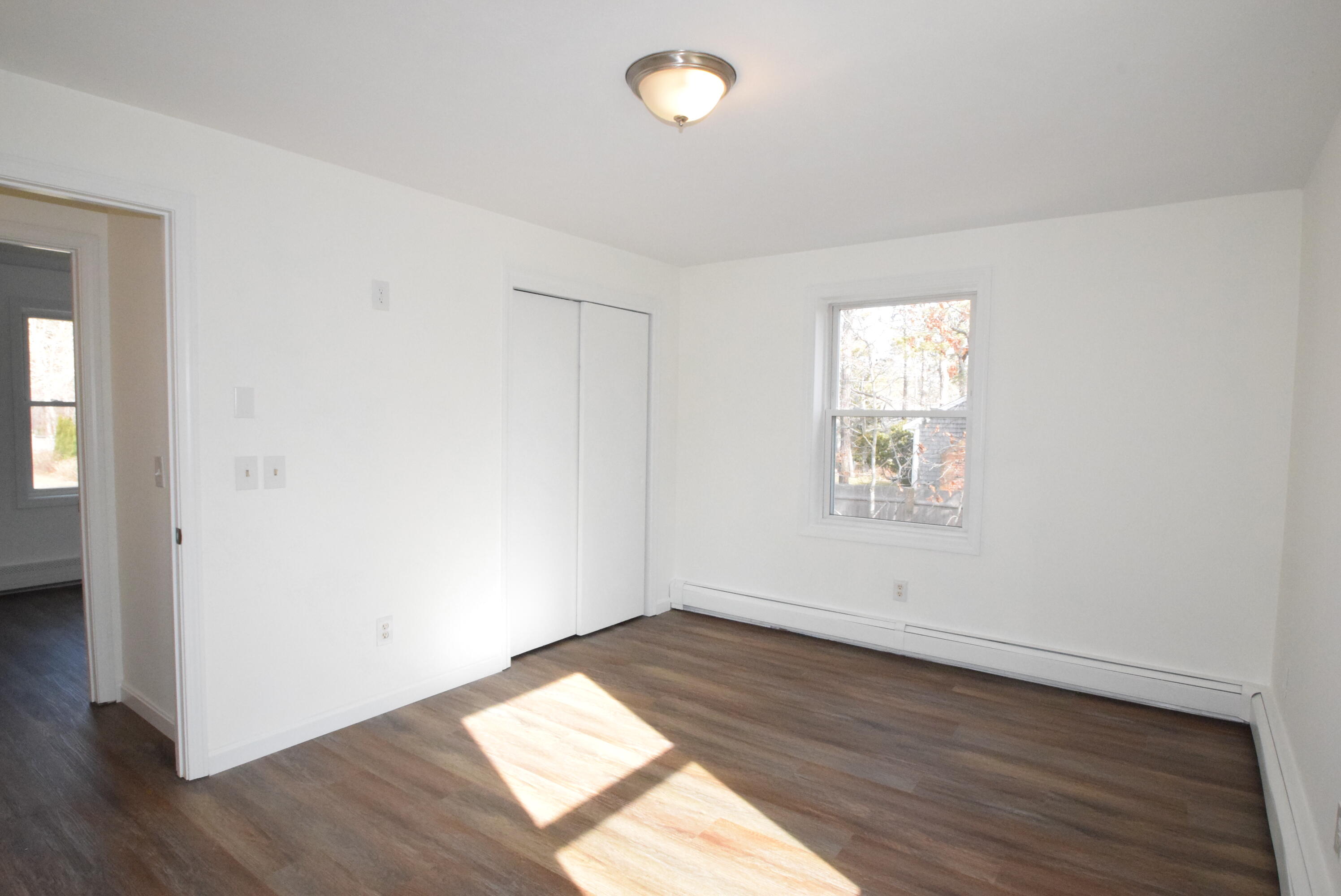 26 Ryder Road Harwich, MA 02645 - Photo 12 of 34 an empty room with wooden floor and windows