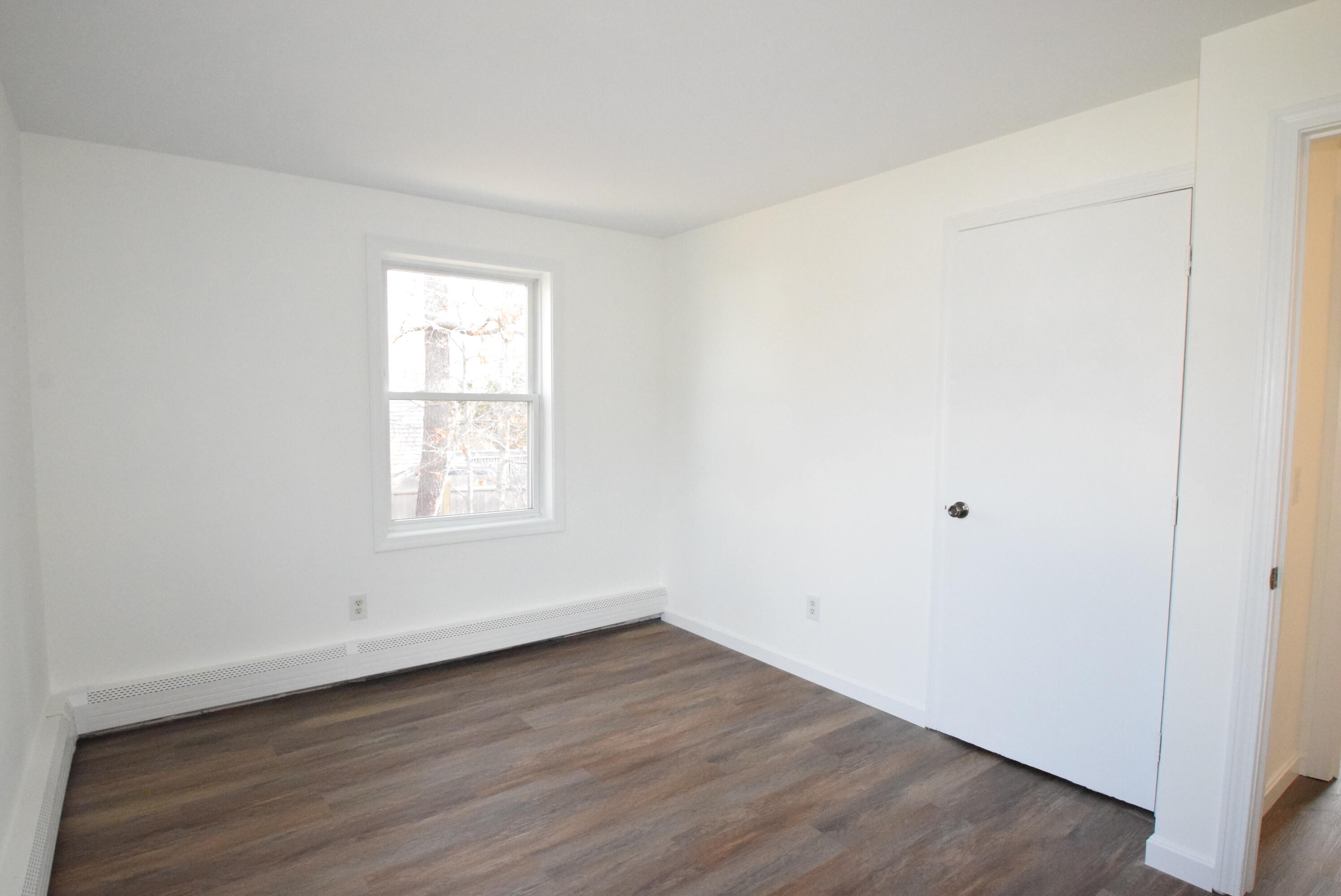 26 Ryder Road Harwich, MA 02645 - Photo 14 of 34 an empty room with wooden floor and window