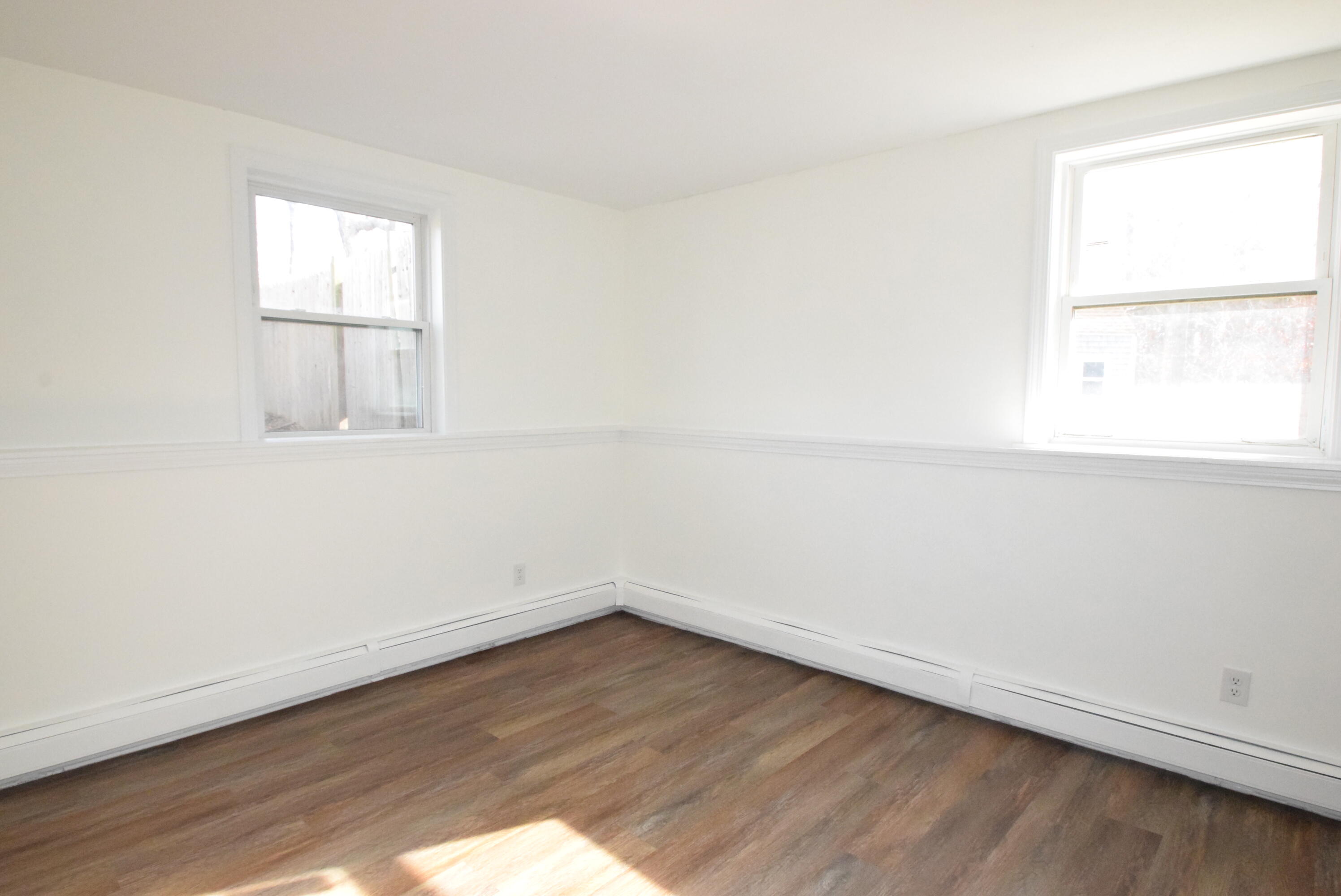 26 Ryder Road Harwich, MA 02645 - Photo 17 of 34 an empty room with wooden floor and window