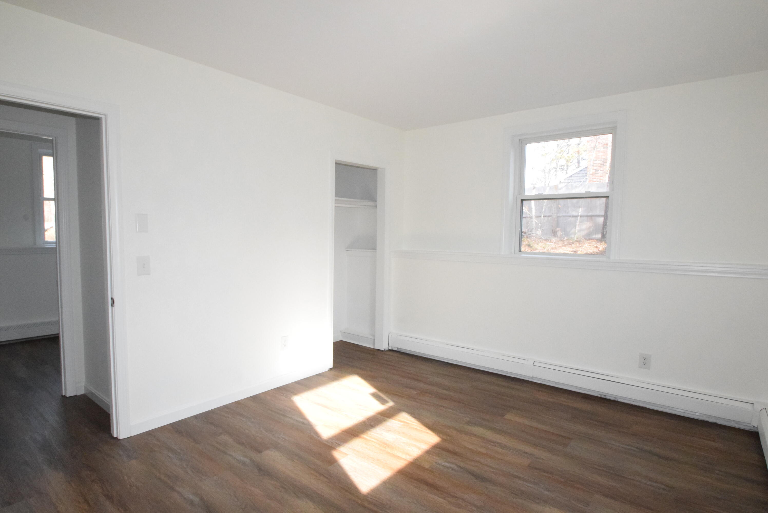 26 Ryder Road Harwich, MA 02645 - Photo 18 of 34 an empty room with wooden floor and windows