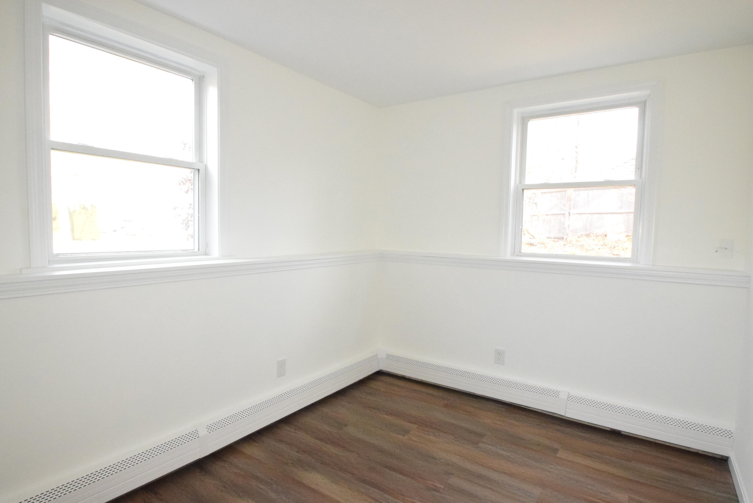 26 Ryder Road Harwich, MA 02645 - Photo 19 of 34 an empty room with wooden floor and windows