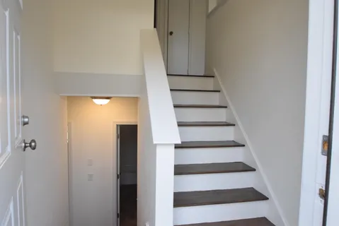 a view of entryway with wooden floor and door