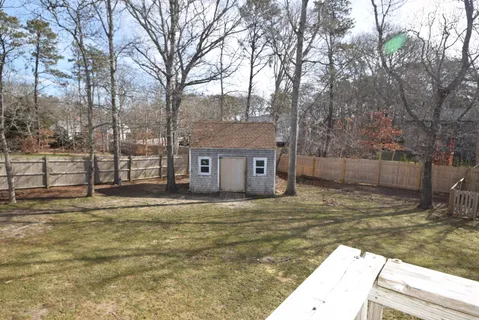 a view of a house with a yard covered in snow