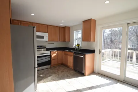 a kitchen with granite countertop a refrigerator and a sink
