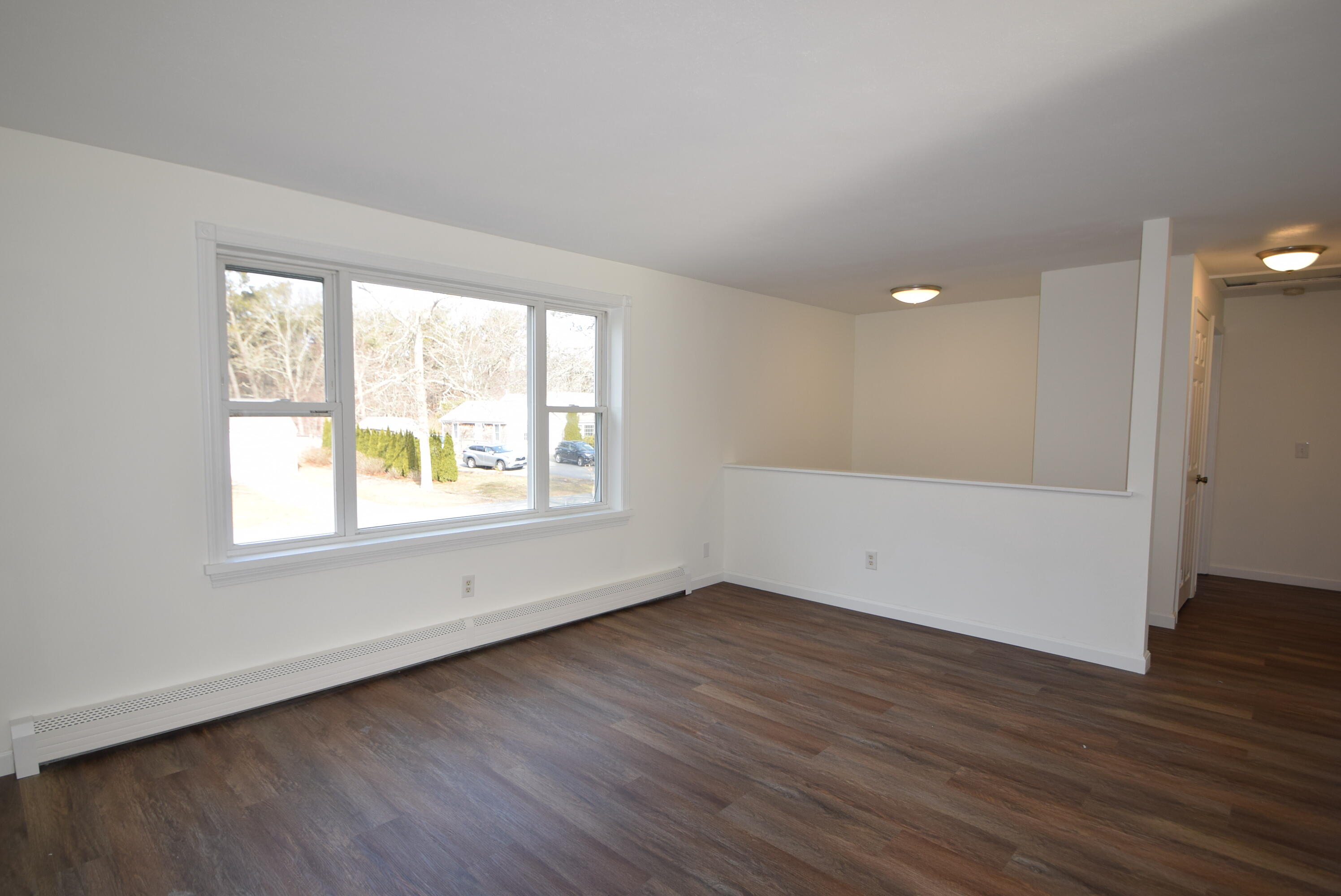 26 Ryder Road Harwich, MA 02645 - Photo 8 of 34 an empty room with wooden floor and windows