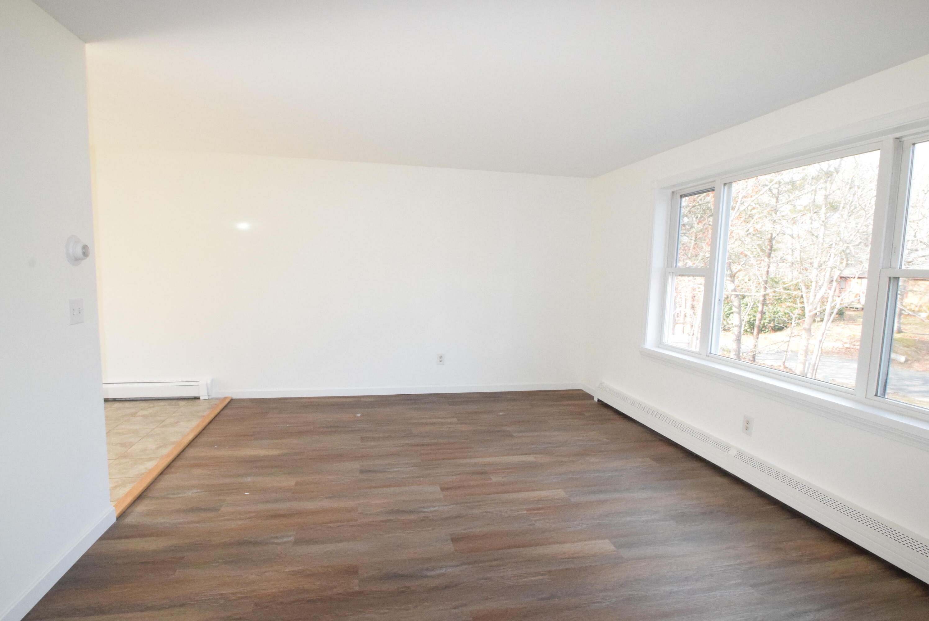 26 Ryder Road Harwich, MA 02645 - Photo 10 of 34 an empty room with wooden floor and windows
