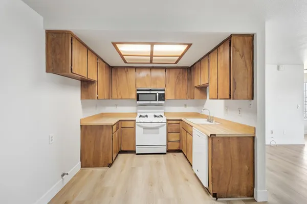 a kitchen with a stove top oven sink and cabinets