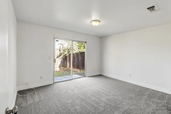 an empty room with floor to ceiling window