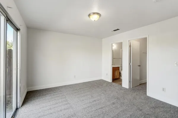 a view of an empty room and a window