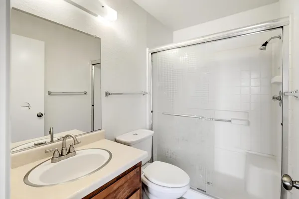 a bathroom with a sink toilet and shower