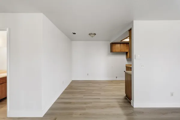 a view of a room with wooden floor