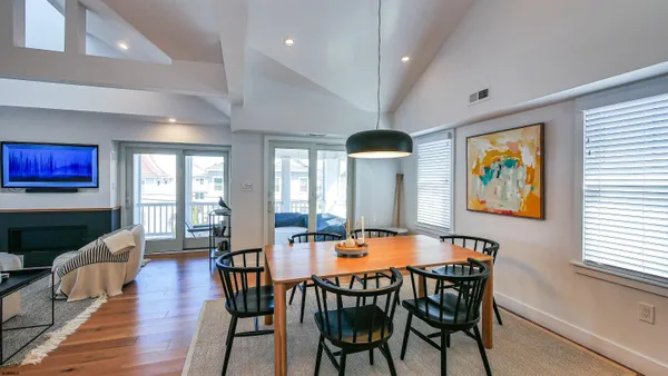 a view of a a dining room with furniture window and wooden floor