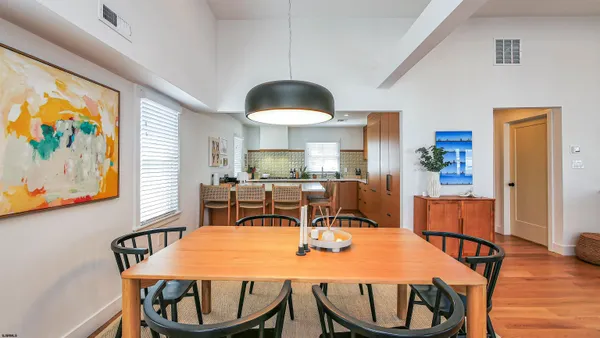 a dining room with furniture and wooden floor