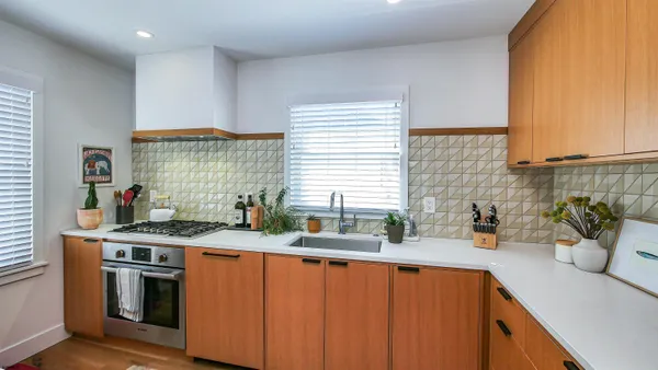 a kitchen with stainless steel appliances a sink window and cabinets