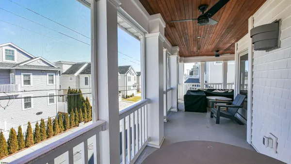 a view of a chairs and table in a balcony