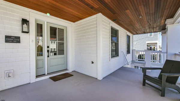 a view of a room with furniture and windows