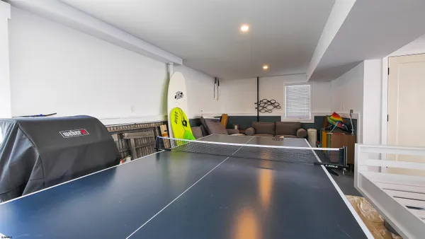 a view of a kitchen with kitchen island and a sink