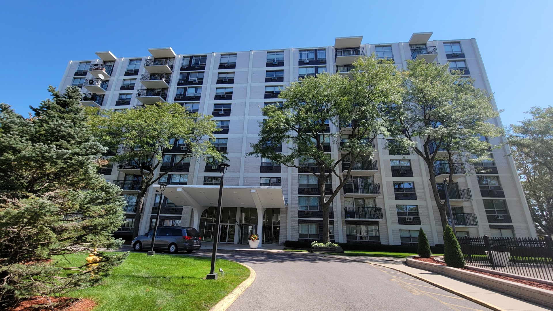 9001 West Golf Road, Unit 4B Des Plaines, IL 60016 - Photo 1 of 21 front view of a building with a yard