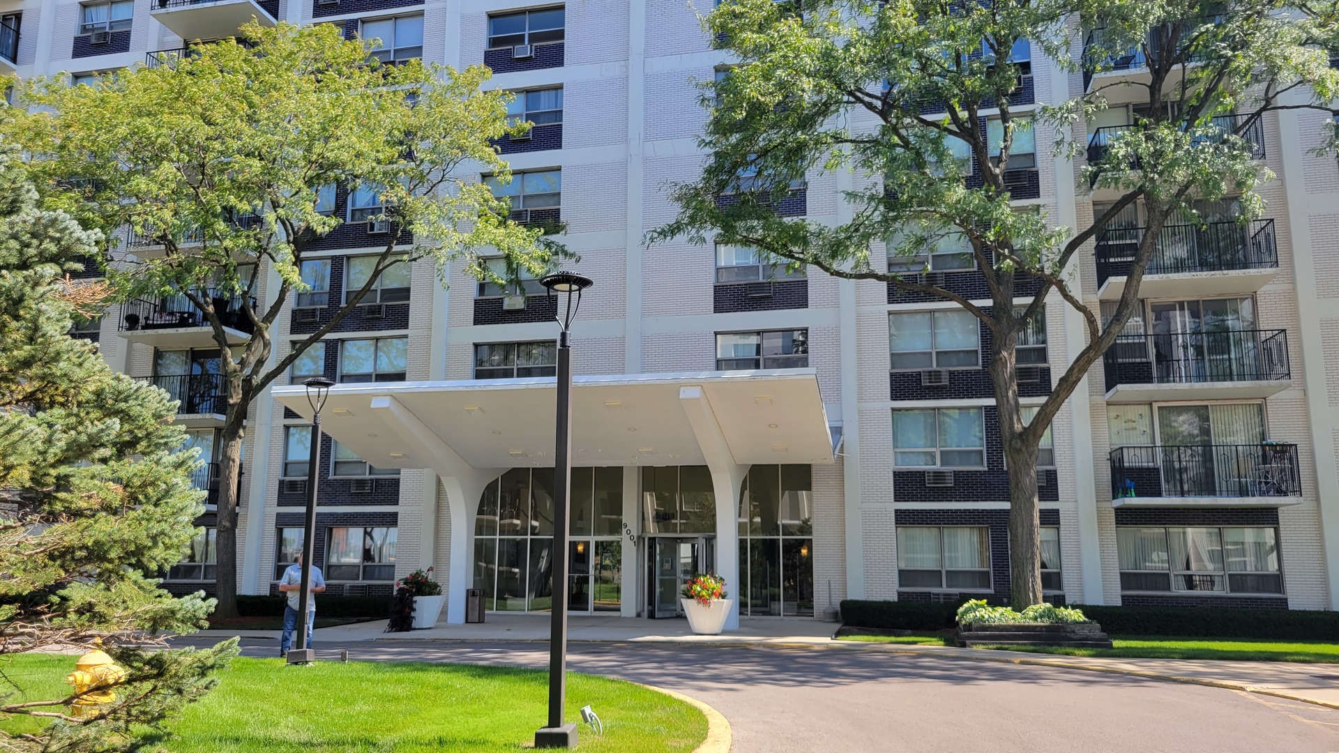 9001 West Golf Road, Unit 4B Des Plaines, IL 60016 - Photo 2 of 21 front view of a building with a garden