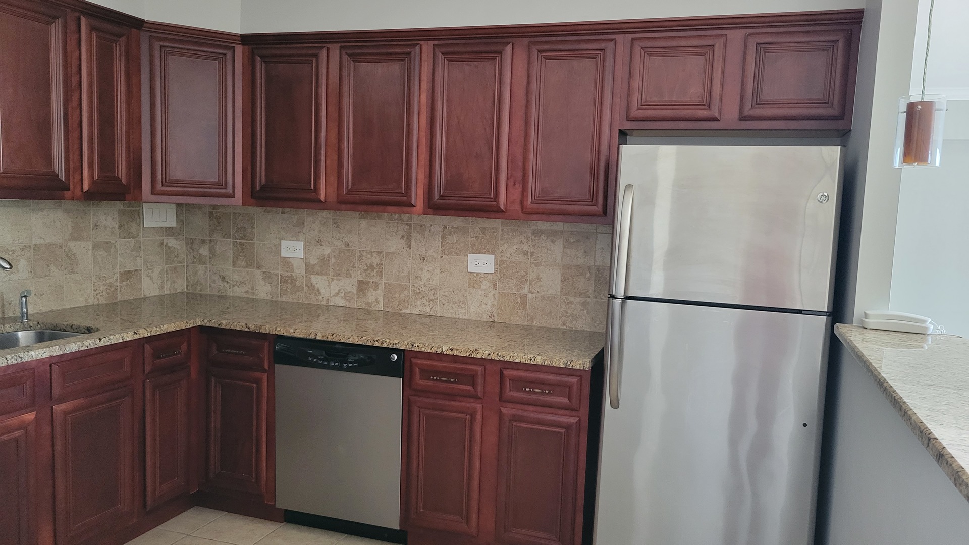 9001 West Golf Road, Unit 4B Des Plaines, IL 60016 - Photo 8 of 21 a kitchen with a refrigerator and cabinets