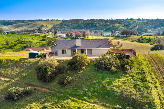an aerial view of a residential houses with outdoor space