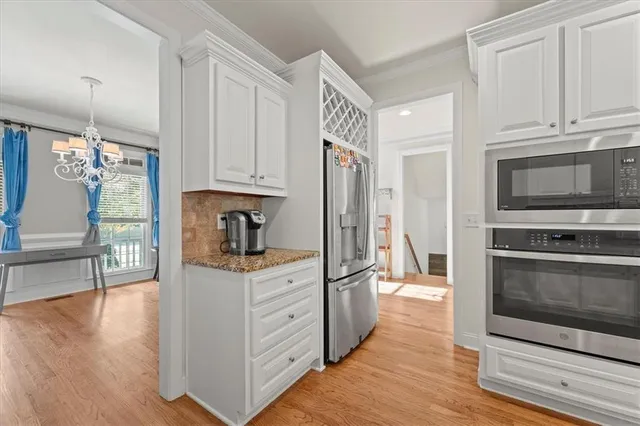 a kitchen with stainless steel appliances granite countertop a stove and a refrigerator