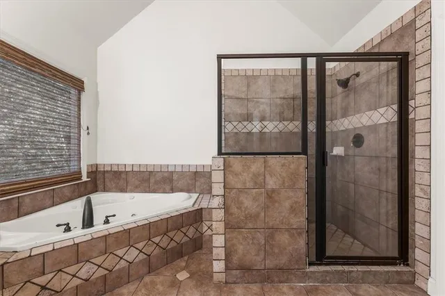 a bathroom with a bathtub and shower