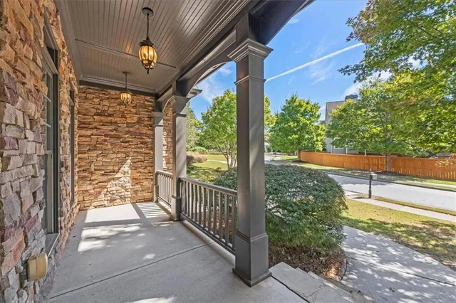 a view of a porch with a floor to ceiling window and wooden fence