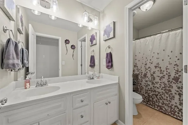 a bathroom with a double vanity sink mirror and shower