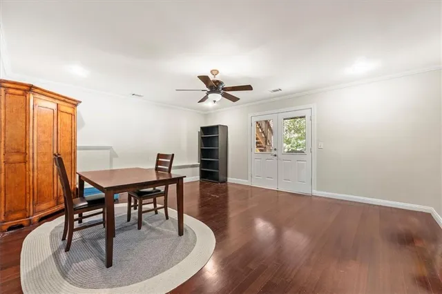 a dining room with furniture window and wooden floor