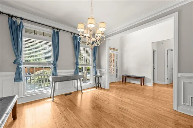 a view of a livingroom with wooden floor and a large window