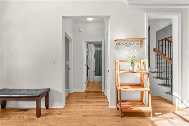a hallway with wooden floor and windows