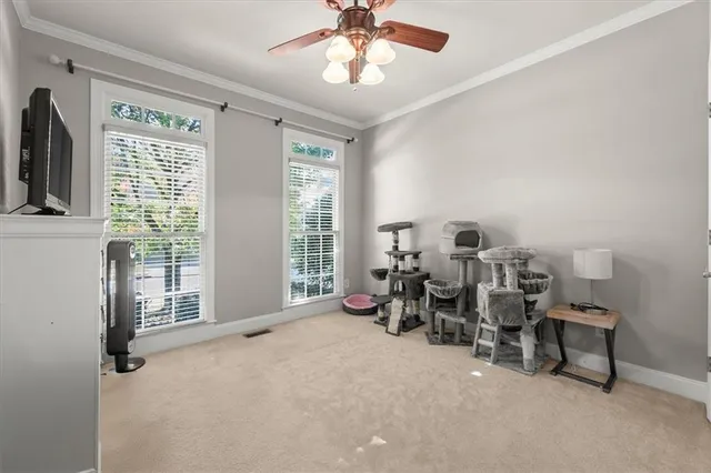 a living room with furniture tv and a window